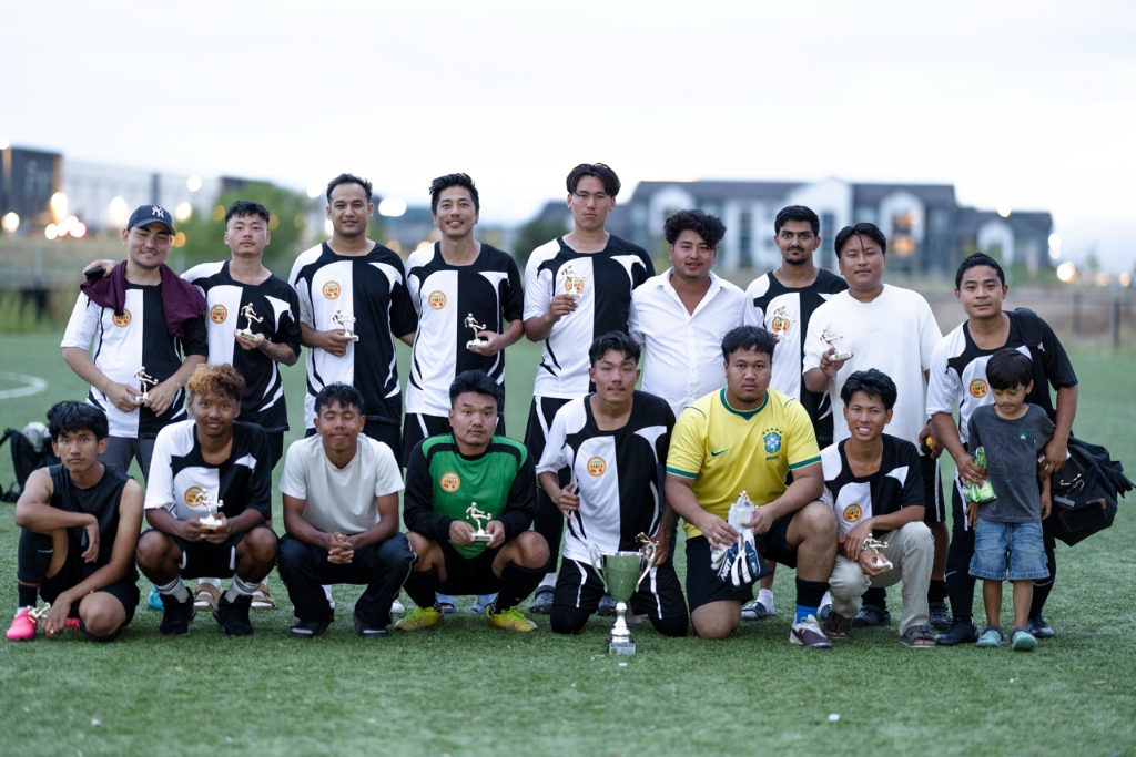 GBCC soccer tournament champions holding trophy and awards